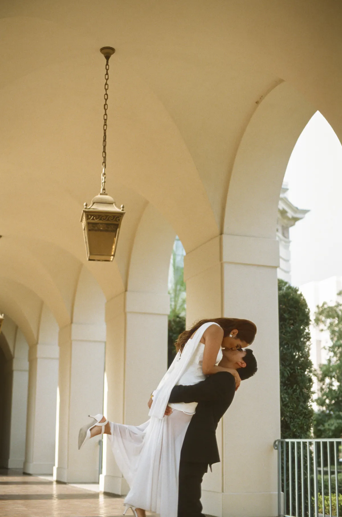 Groom lifting bride — editorial film frame