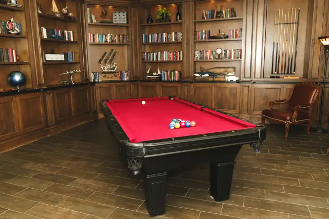 Wood-paneled game room with a red pool table at Villa de Amore in Temecula