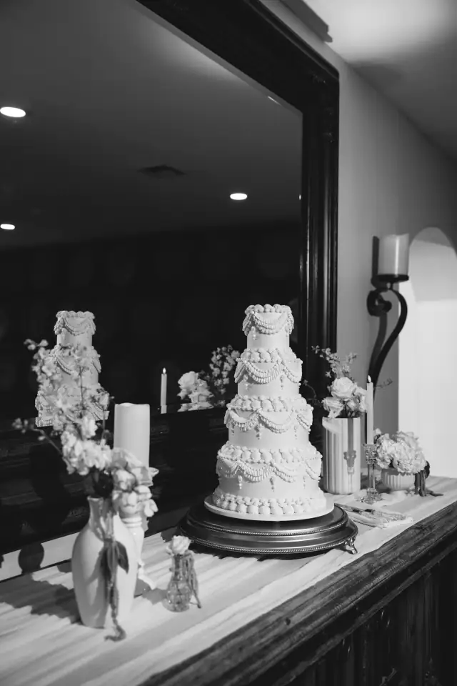 Three-tier wedding cake displayed at the Villa de Amore reception