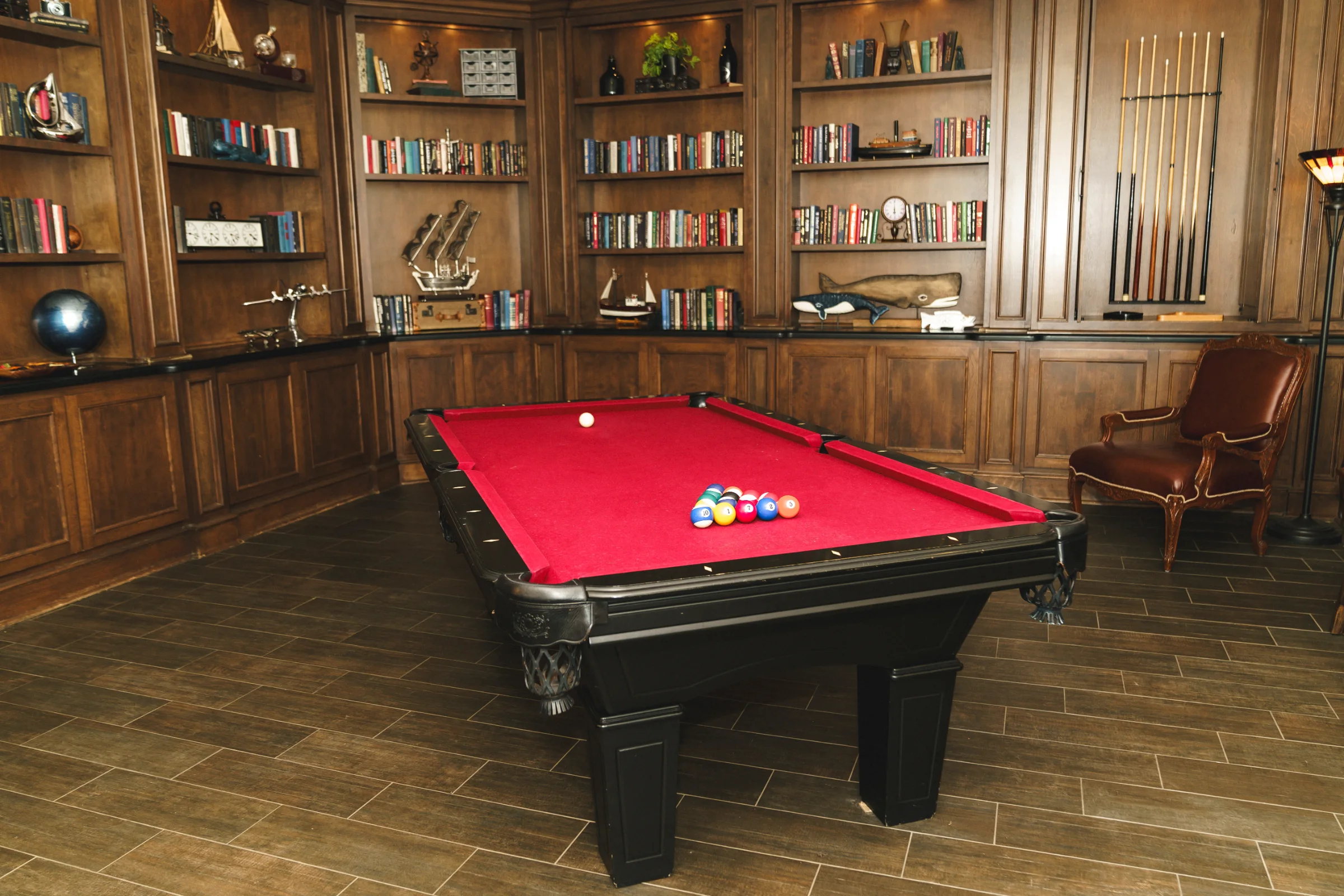 Wood-paneled game room with a red pool table at Villa de Amore in Temecula