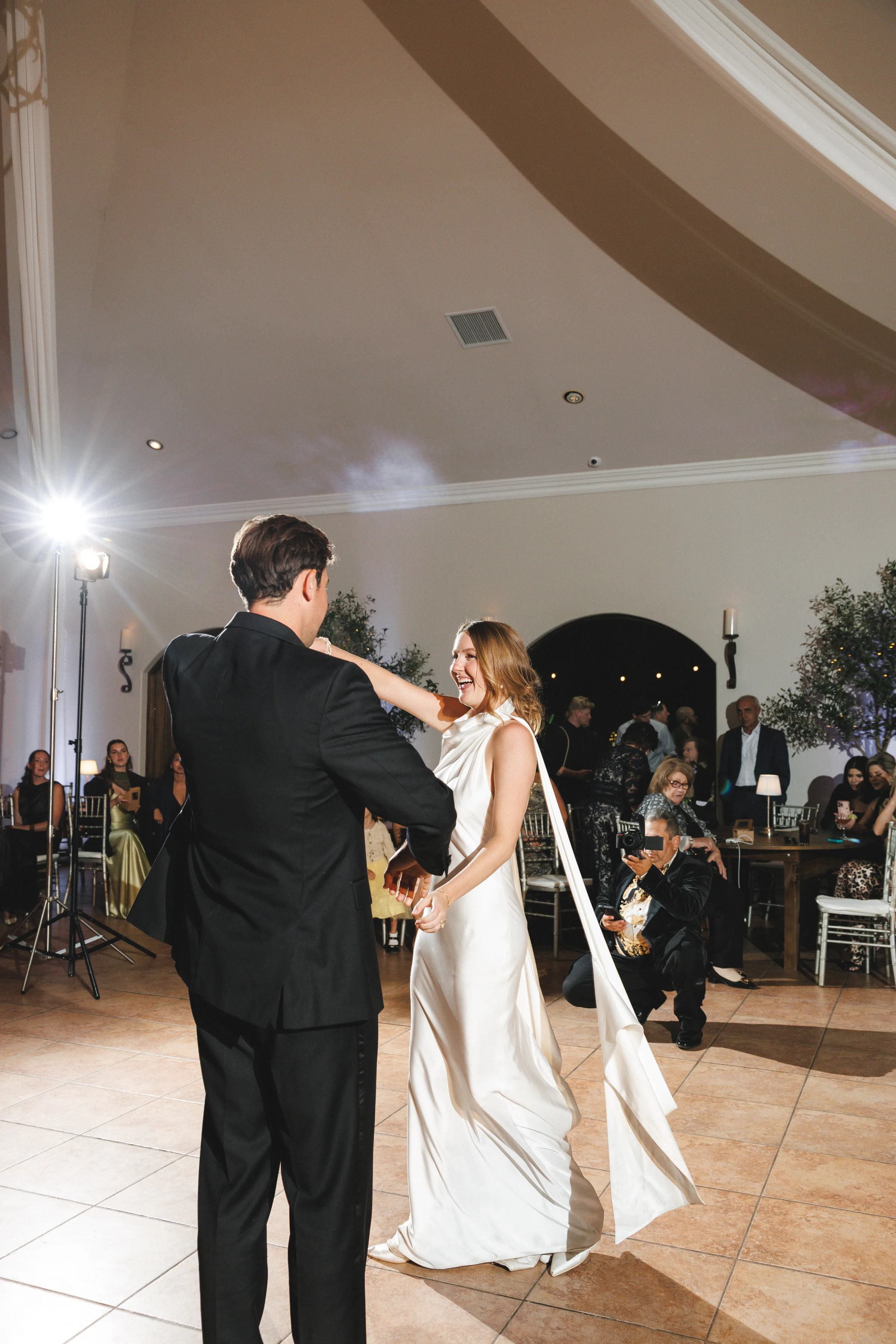 Newlyweds sharing their first dance at the indoor reception